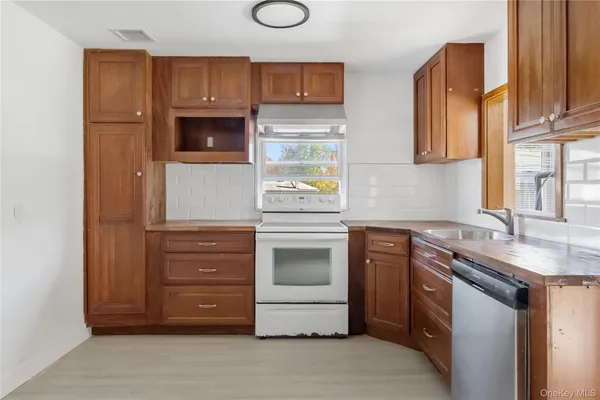 a kitchen with stainless steel appliances granite countertop a sink and a stove top oven