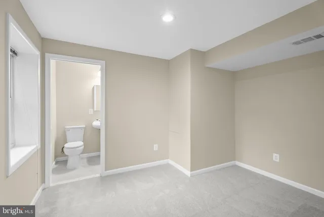 a view of an empty room and a bathroom