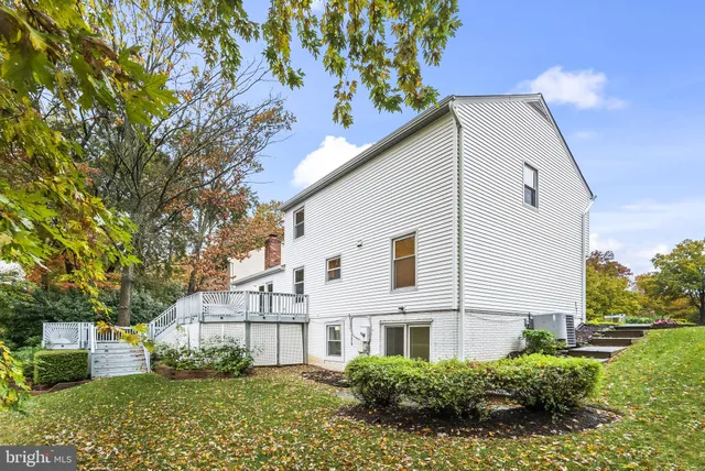 a view of a white house with a yard