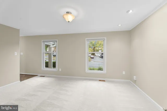 an empty room with windows and entrance