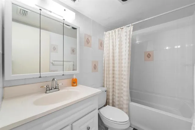 a bedroom with bed and a potted plant