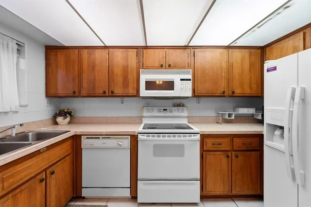 a kitchen with stainless steel appliances granite countertop a sink a stove and cabinets