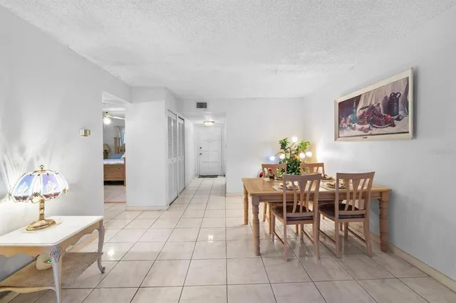 a dining room with large window table and chairs