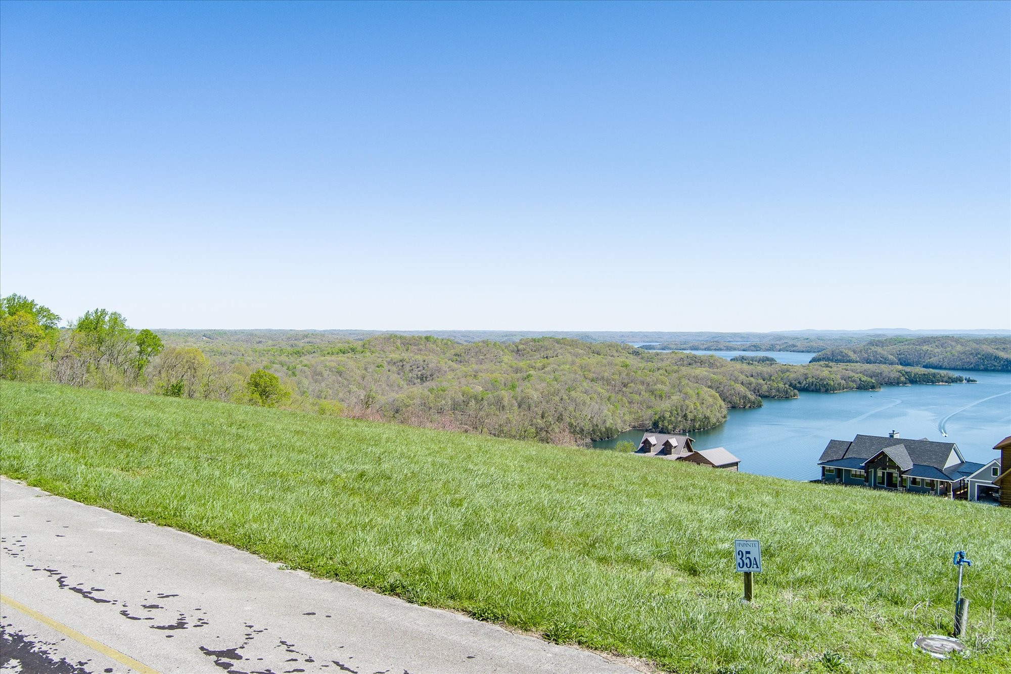 33 A Swan Ridge Road Celina, TN 38551 - Photo 1 of 10 a view of a river and garden with trees in the background