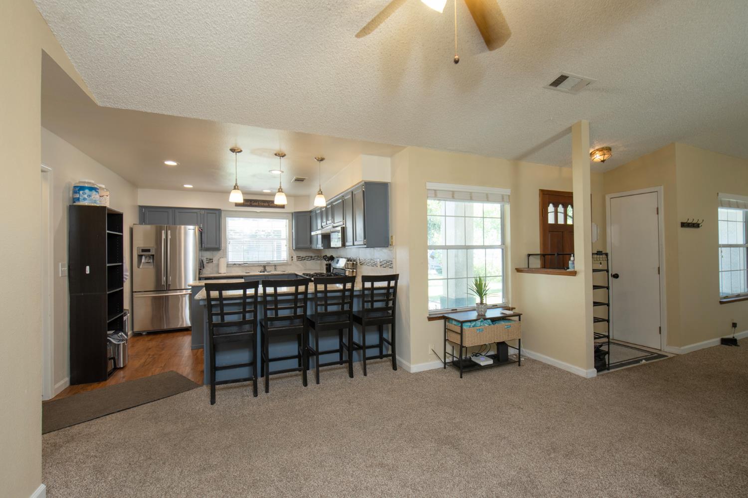 101 Cantebury Drive Lemoore, CA 93245 - Photo 8 of 16 a dining room with furniture and a chandelier