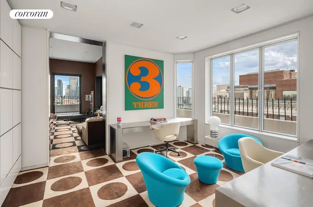 a living room with furniture and a floor to ceiling window