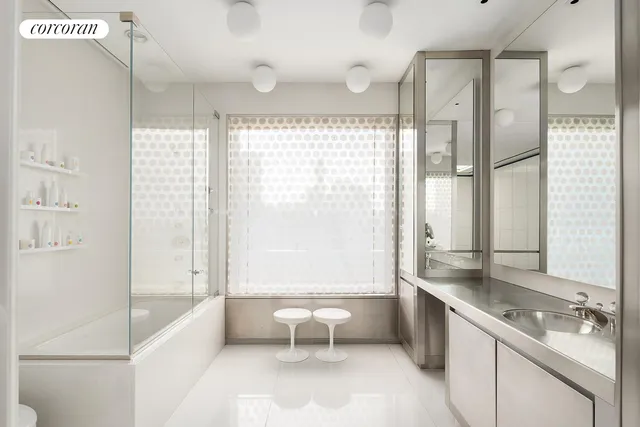 a bathroom with a double vanity sink toilet and shower
