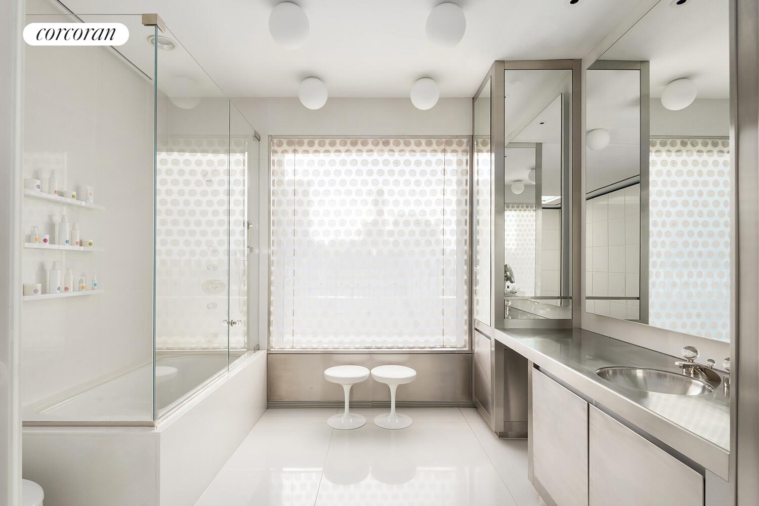 1 Sutton Place South, Unit PH Manhattan, NY 10022 - Photo 13 of 26 a bathroom with a double vanity sink toilet and shower