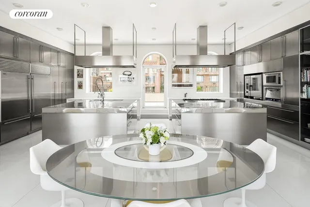 a large kitchen with a table and chairs