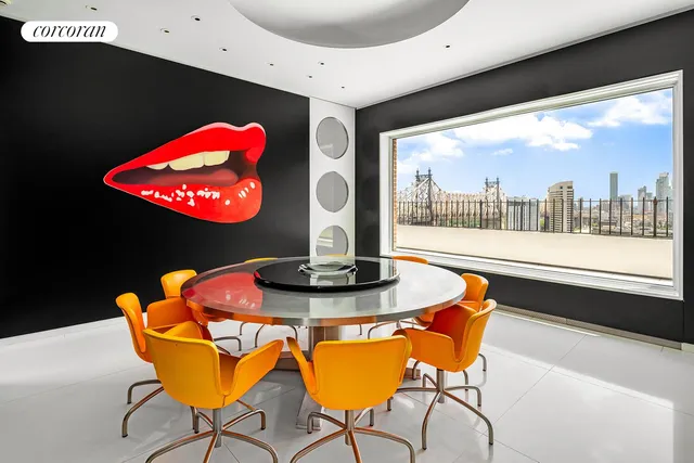 a dining room with furniture and a floor to ceiling window