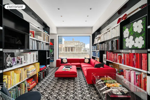 a living room with lots of furniture and a book shelf