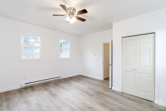 wooden floor in an empty room with a window