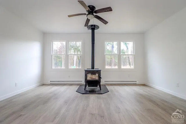 a living room with hardwood floor and windows