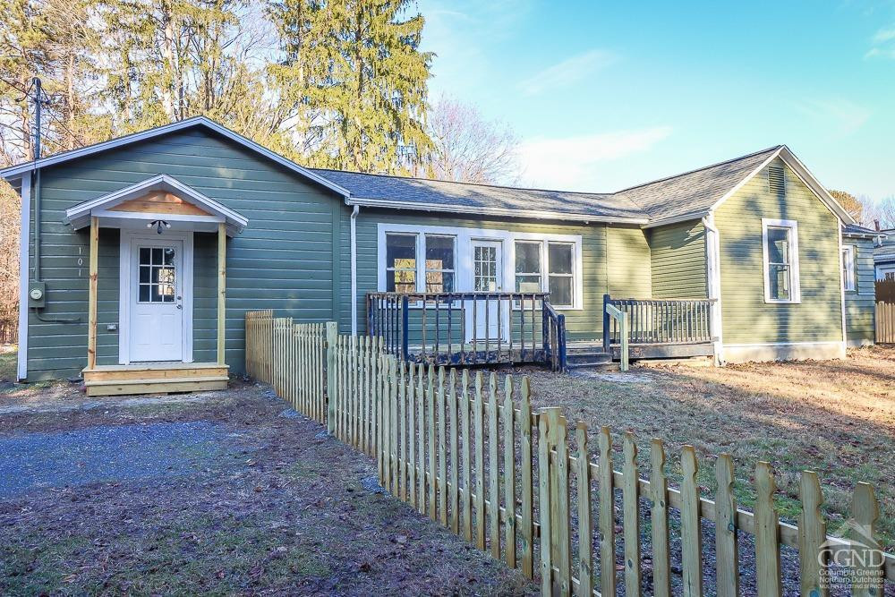 101 Orinsekwa Road Valatie, NY 12184 - Photo 4 of 23 a view of a house with wooden fence next to a road