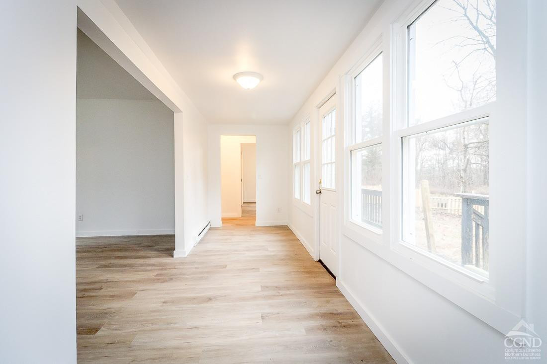 101 Orinsekwa Road Valatie, NY 12184 - Photo 5 of 23 a view of an empty room with wooden floor and a window