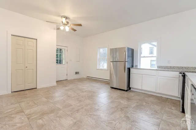 a view of a kitchen with a refrigerator and cabinet