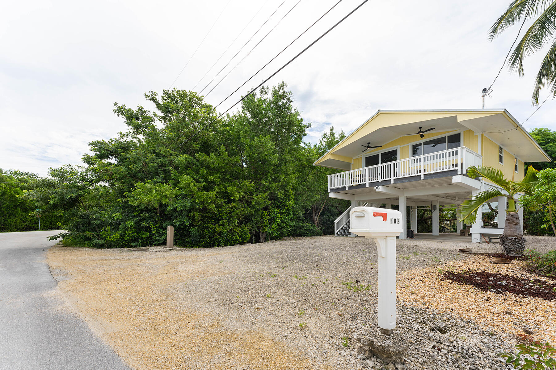 102 South Drive Key Largo, FL 33037 - Photo 2 of 26 a front view of a house with a yard