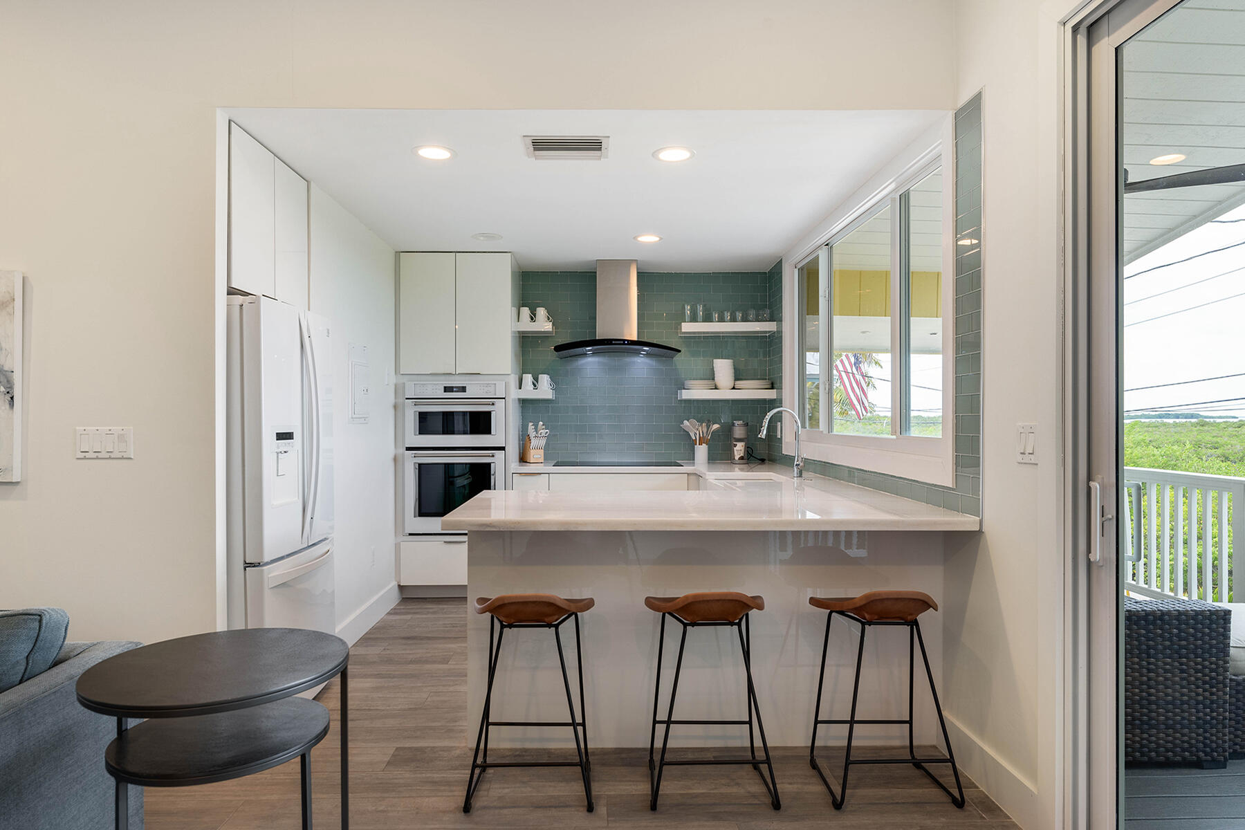 102 South Drive Key Largo, FL 33037 - Photo 7 of 26 a kitchen with kitchen island a table and chairs in it