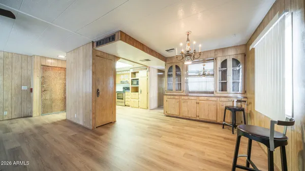 a very nice looking room with wooden floor and windows