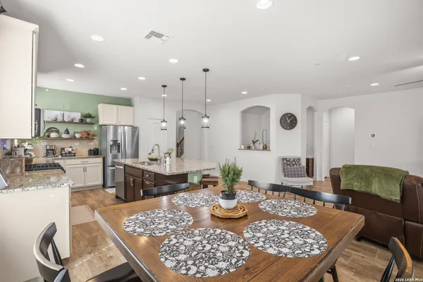 a large kitchen with a table and chairs