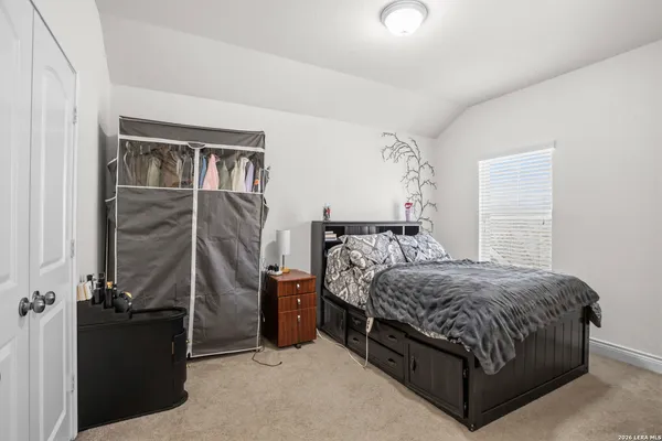 a bedroom with a bed next to a window