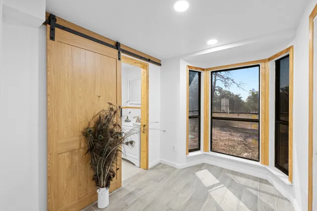 a view of a room with window and front door