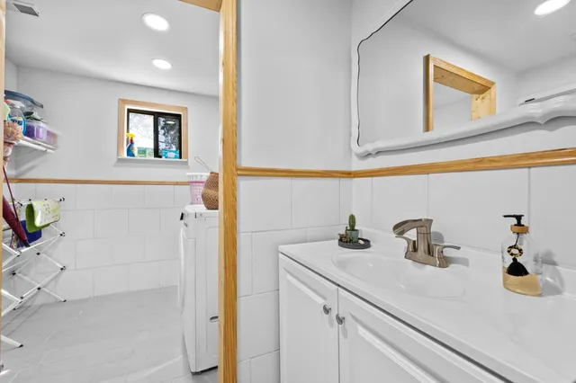 a bathroom with a sink a mirror and vanity