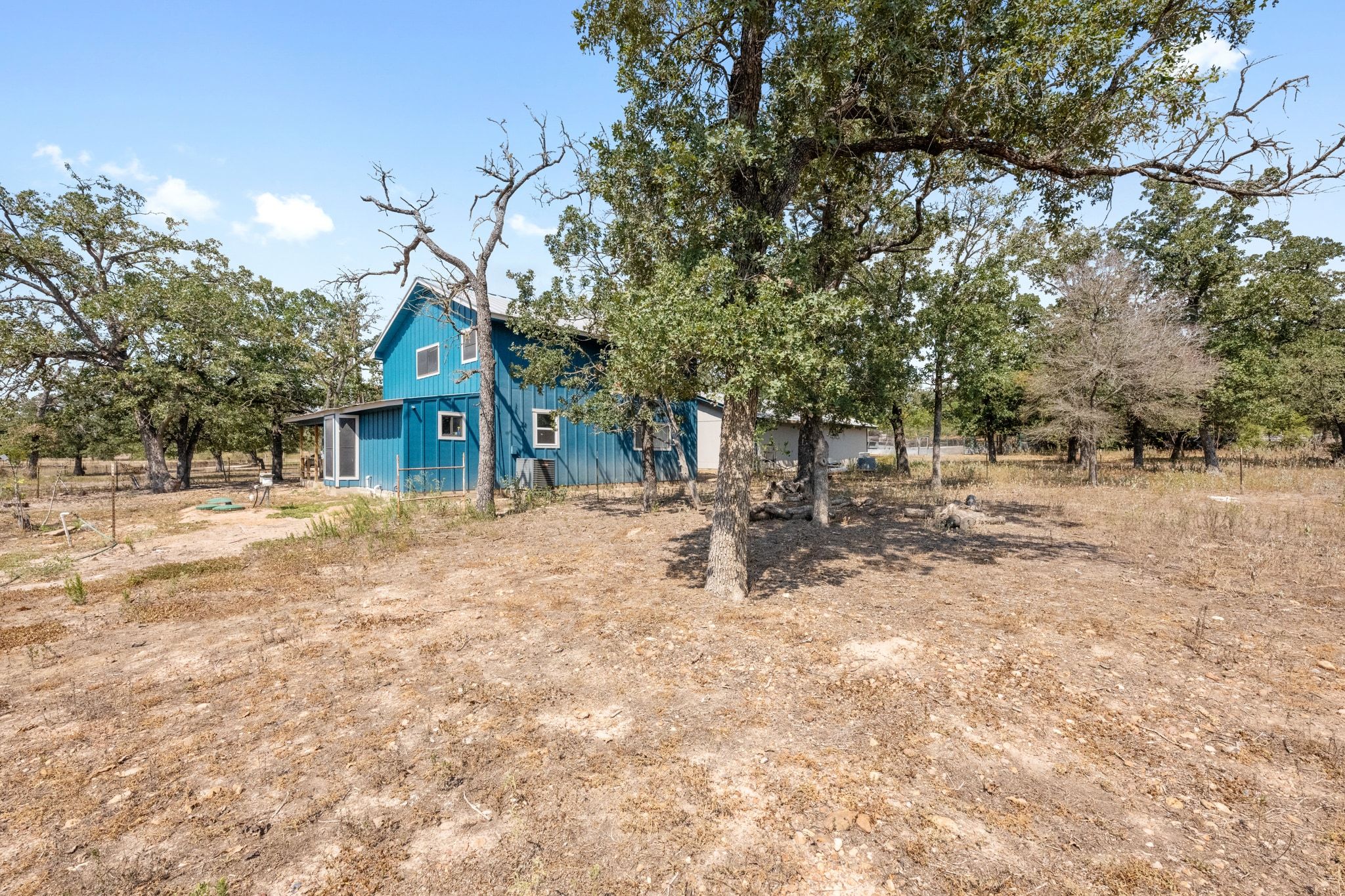 376 Jones Road Cedar Creek, TX 78612 - Photo 36 of 40 a view of house with yard and trees in the background
