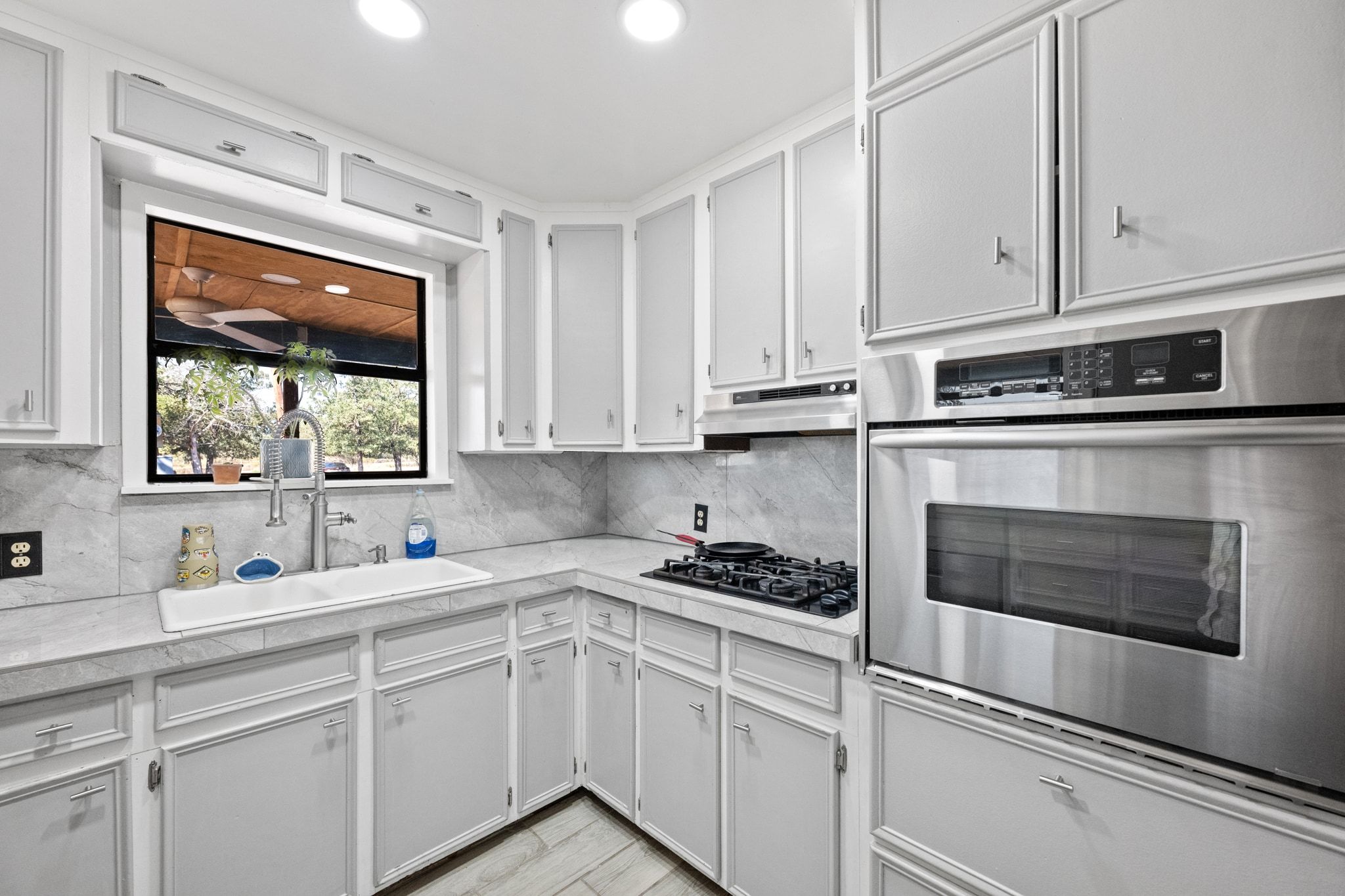 376 Jones Road Cedar Creek, TX 78612 - Photo 8 of 40 a kitchen with cabinets appliances a sink and a window