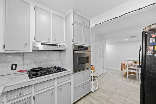a kitchen with stainless steel appliances granite countertop a stove and a refrigerator