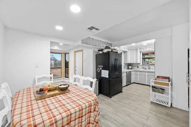 a bedroom with a bed cabinets and wooden floor
