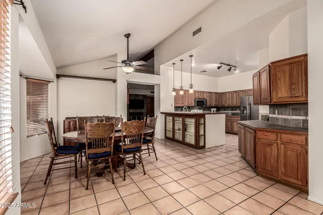 a kitchen with stainless steel appliances kitchen island granite countertop a sink and cabinets