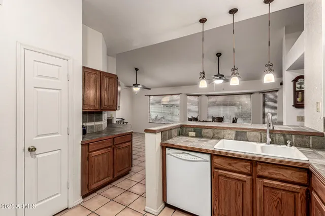 a kitchen with stainless steel appliances granite countertop a sink and cabinets
