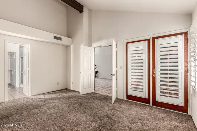 an empty room with closet and a window