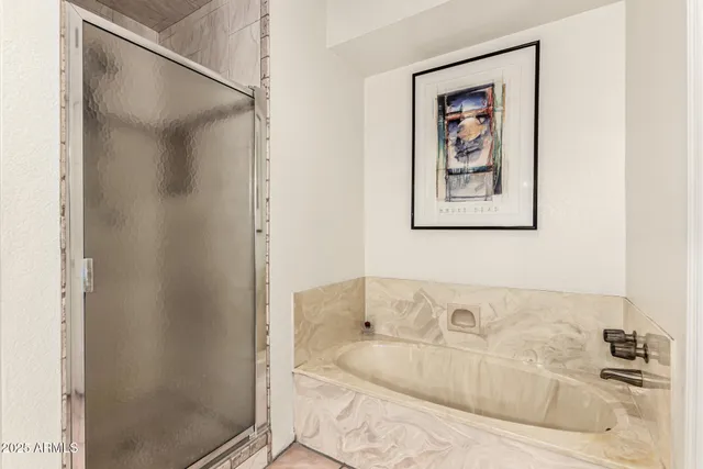 a bathroom with a tub and shower