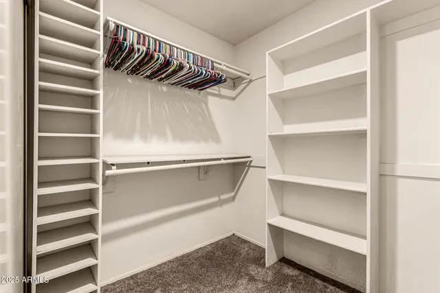 a view of walk in closet with empty racks