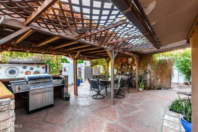 a view of a patio with a table and chairs under a umbrella