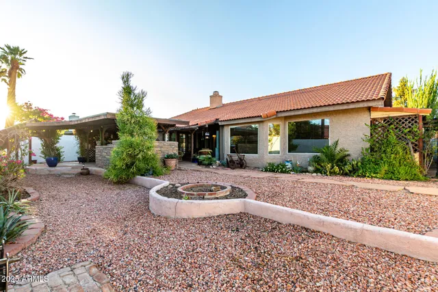 a backyard of a house with a tree