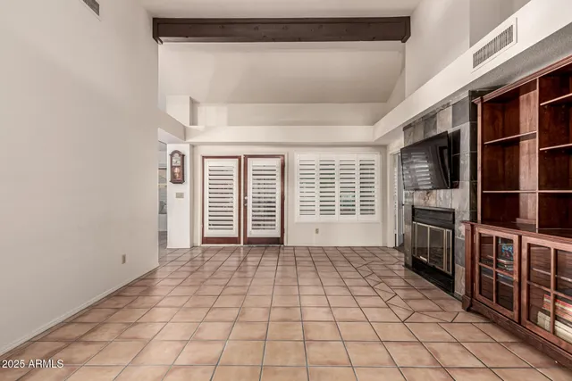 a view of an empty room with a fireplace
