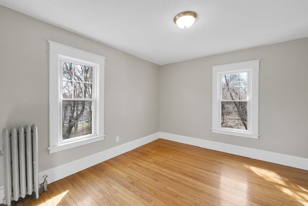 186 Belvidere Street Springfield, MA 01108 - Photo 32 of 42 a view of an empty room with a window and wooden floor