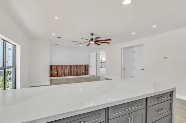a living room with furniture and a ceiling fan