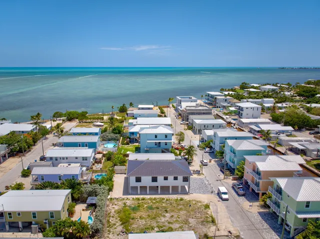 an aerial view of a houses with a lake view