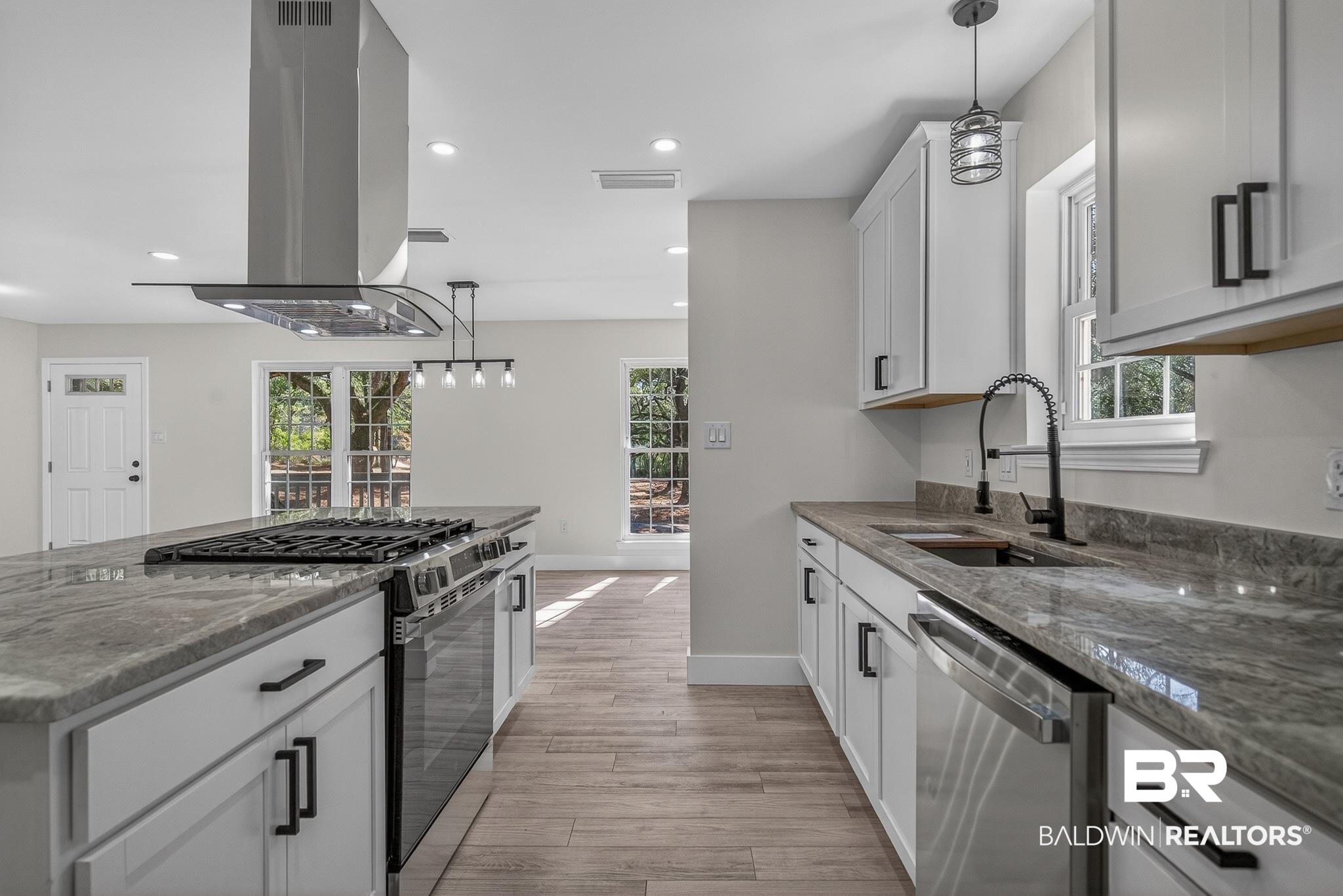 10650 Old Pascagoula Road Theodore, AL 36582 - Photo 29 of 77 Kitchen with decorative light fixtures, white cabinetry, dark stone counters, and gas range oven