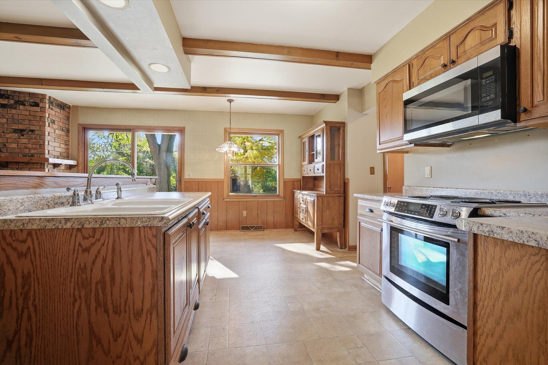14235 West Maylore Drive New Berlin, WI 53151 - Photo 10 of 40 Kitchen w/SS Oven & Microwave. Beam Ceiling