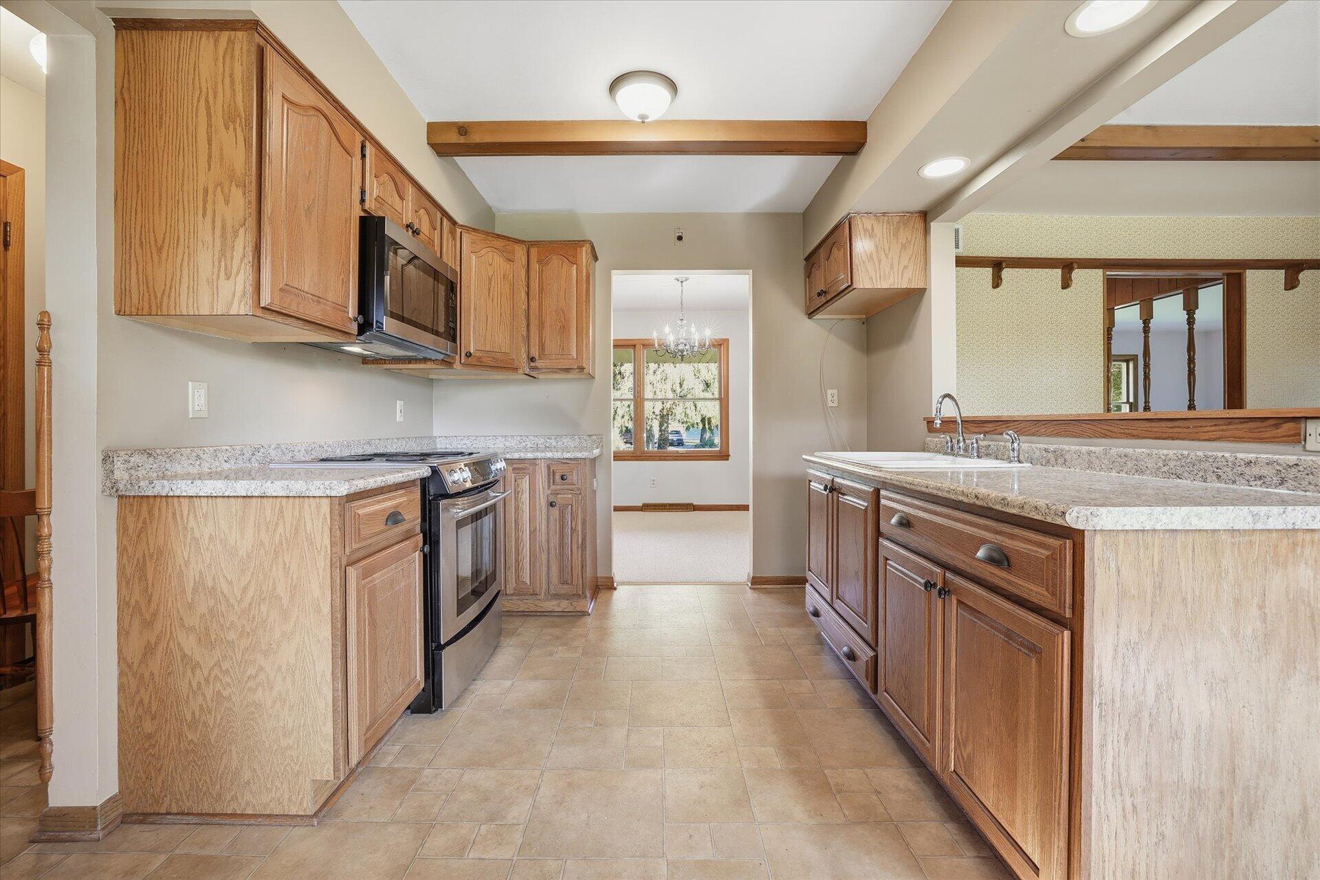 14235 West Maylore Drive New Berlin, WI 53151 - Photo 11 of 40 Kitchen w/SS Oven & Microwave. Beam Ceiling