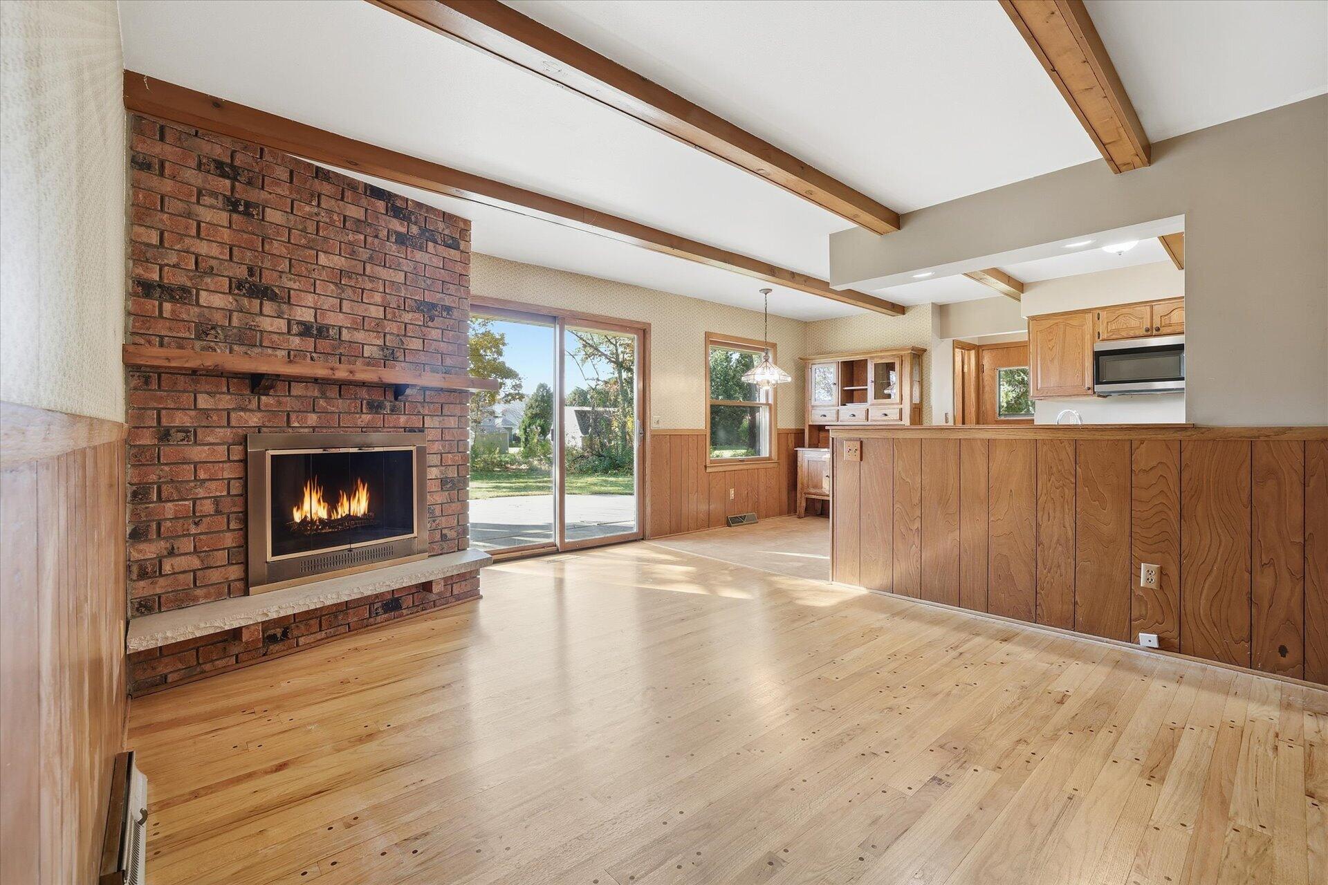 14235 West Maylore Drive New Berlin, WI 53151 - Photo 16 of 40 Family Room w/Natural Fireplace, Wood Floors, & Beam Ceiling