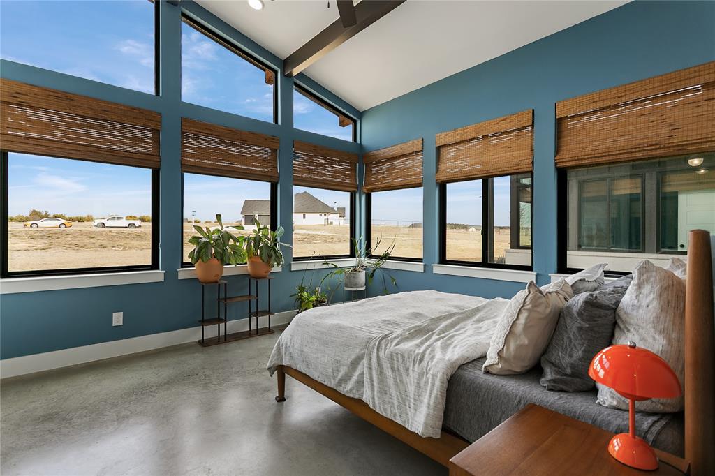 12964 Torello Court Godley, TX 76044 - Photo 19 of 40 a bedroom with a bed and large windows