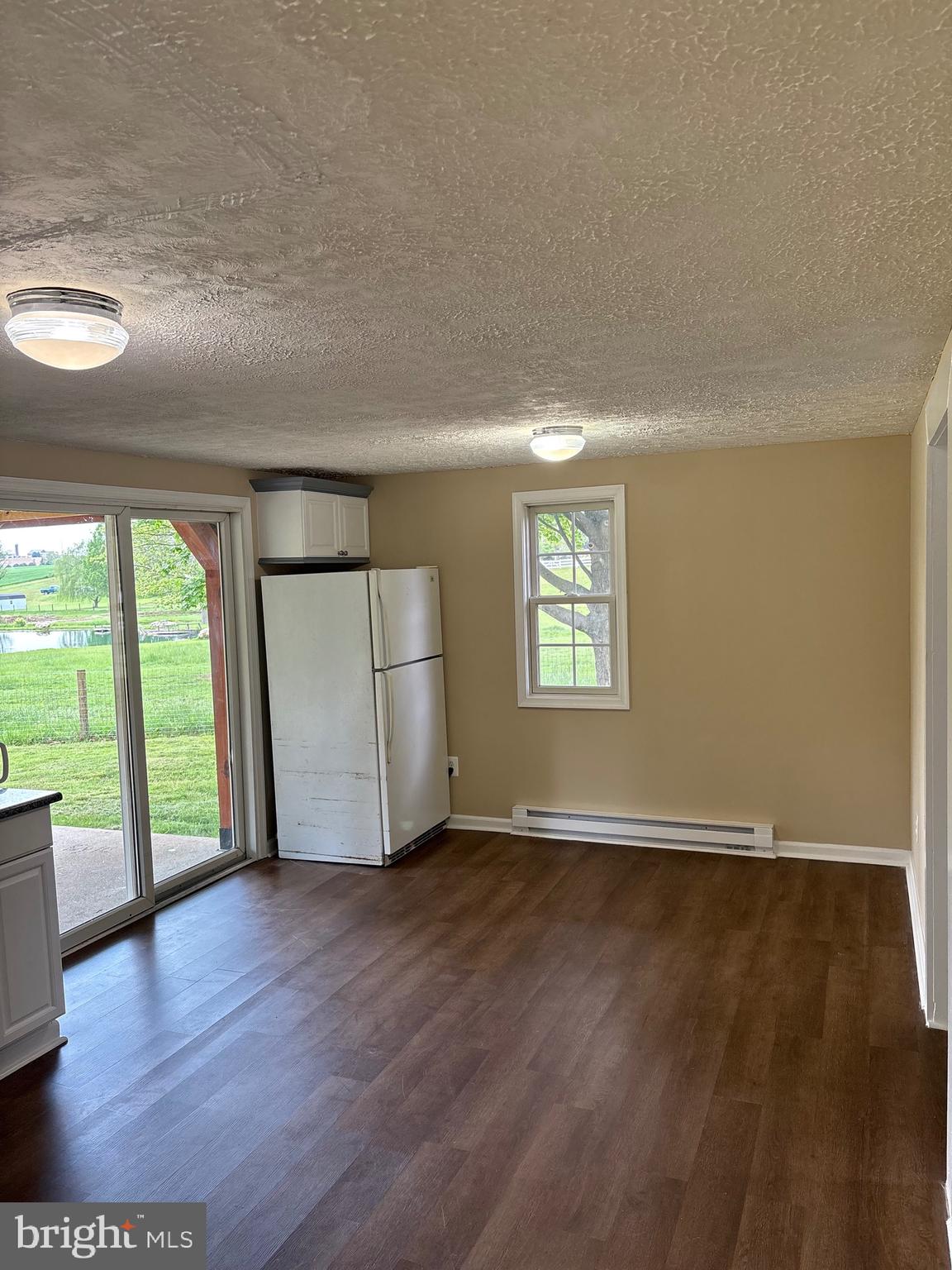 933 Buck Road Quarryville, PA 17566 - Photo 8 of 8 an empty room with wooden floor and windows