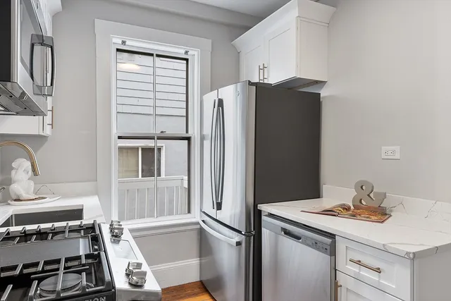 a kitchen with a refrigerator and a stove