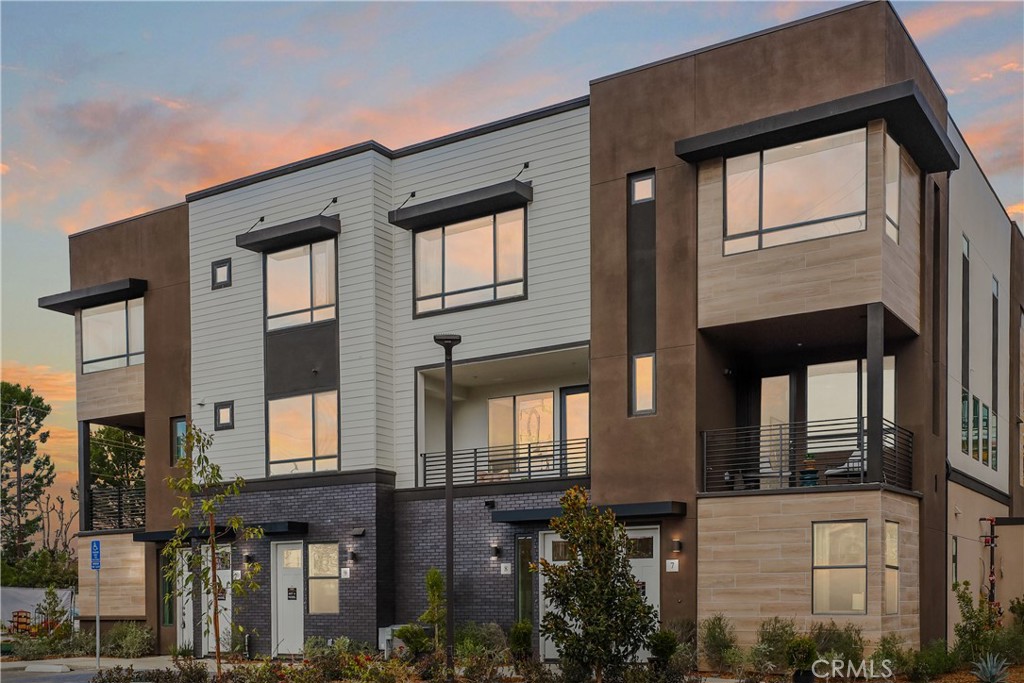 a front view of a residential apartment building with a yard